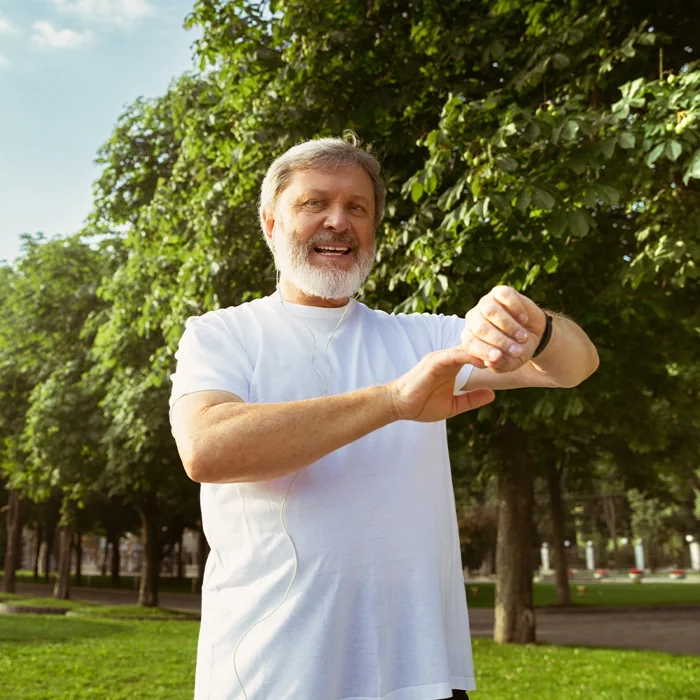 Energetic man outdoors checking his watch