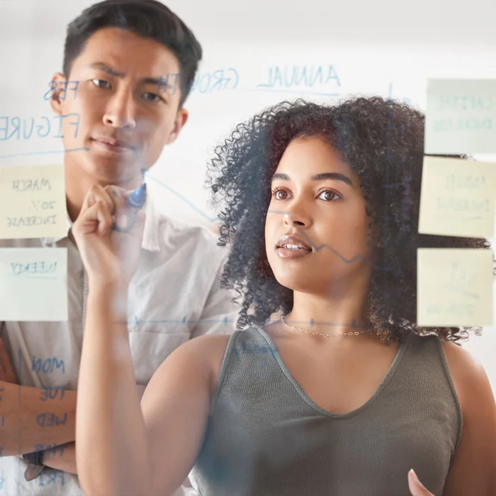 Colleagues planning on a glass board